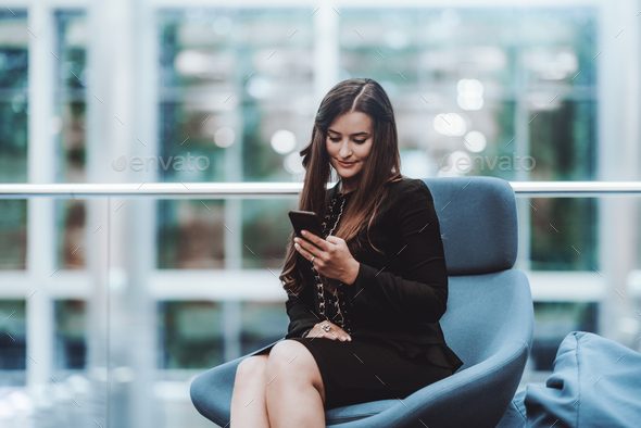 A business lady using her smartphone - Stock Photo - Images
