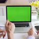 Husband and wife in kitchen video chatting with their friends or family using laptop green screen  - VideoHive Item for Sale