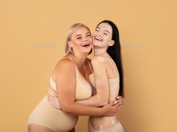 Portrait Of Two Happy Body Positive Women In Underwear Over Beige  Background Stock Photo by Prostock-studio