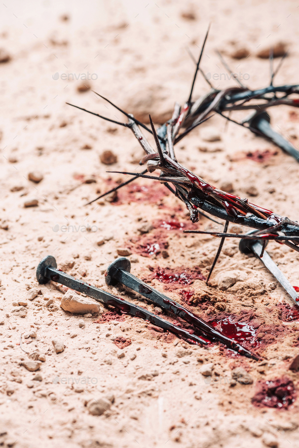 Crown of thorns, bloody nails on sand background. Good Friday, Passion of  Jesus Christ. Christian Stock Photo by jchizhe