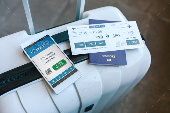 Suitcase with passport, boarding pass and covid passport - Stock Photo - Images