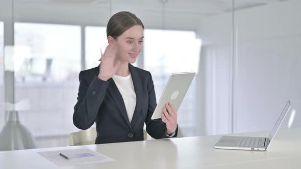 Young Businesswoman Doing Video Chat on Tablet in Office alt
