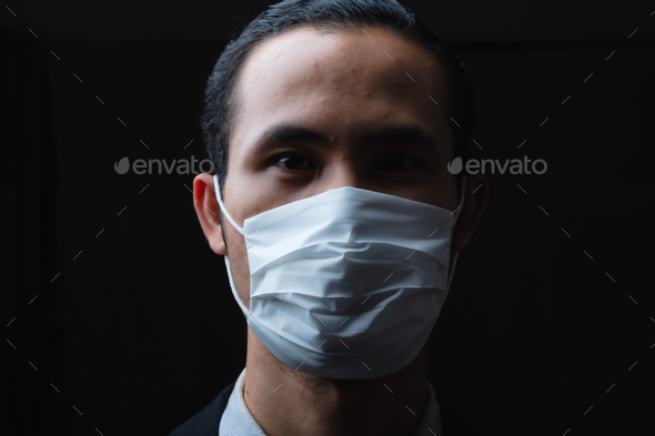 Businessman in suit wearing a face mask, People pay attention to the virus