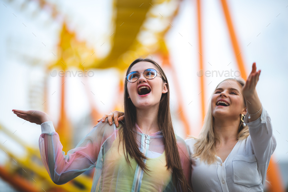 Group of happy best friends laughing and having fun at amusement park ...