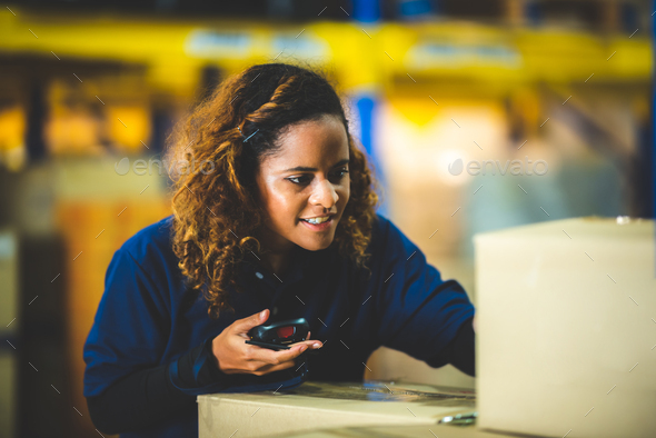 warehouse worker using bar code scanner to analyze newly arrived goods for further placement - Stock Photo - Images