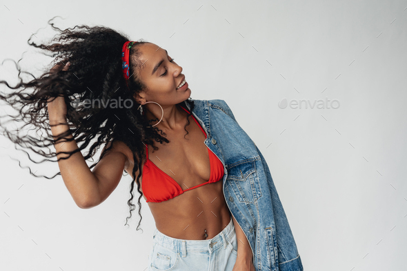 attractive black african american woman posing in stylish hipster
