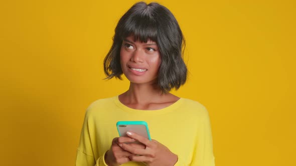 Young Woman Received Awaited Pleasant Message on Mobile Phone Thinking to Answer alt