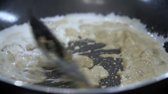 Boil and Dissolve Thai Yellow Curry Paste in White Coconut Milk in a Hot Pan alt