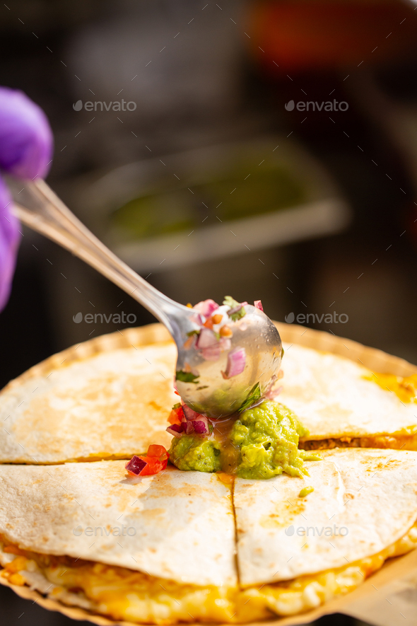 Mexican street fast food with quesadillas. Chef preparing food in food truck