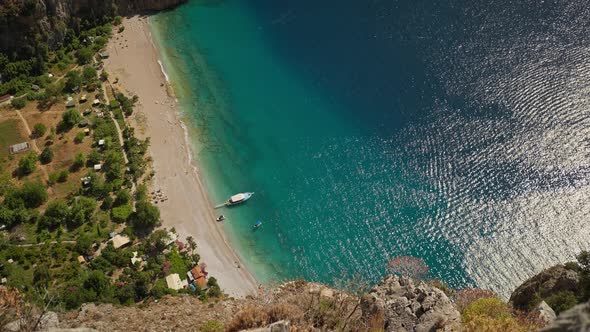 Aerial Top Down View of the Turquoise Blue Water at Butterfly Valley with Large Tourist Boats alt