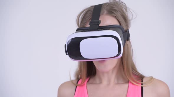 Face of Blonde Woman Using Virtual Reality Headset alt