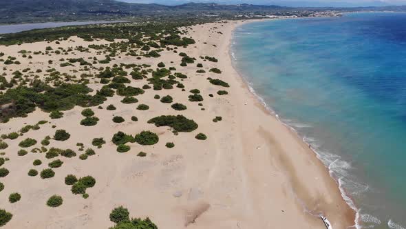 Aerial footage flying across the beach and coastal vacation area called St George South in Corfu alt