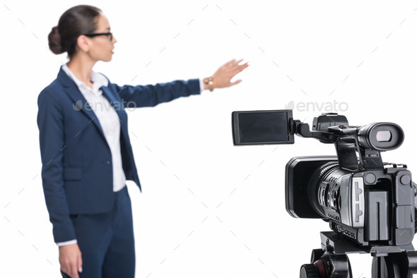 beautiful female newscaster presenting something in front of camera ...