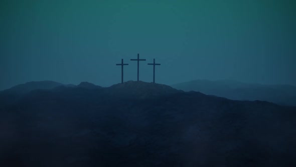 Atmospheric, dark image of three crosses silhouetted on the top of a mountain. alt