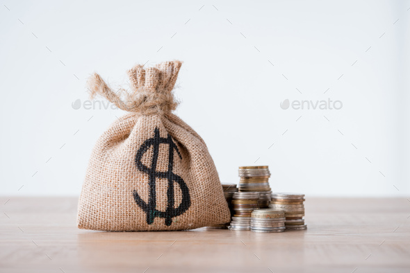 Bag full money with dollar sign, gold coins, - Stock