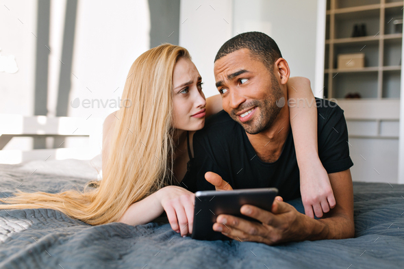 Portrait lovely couple of cute sincere young woman with long blonde hair and handsome guy talking on
