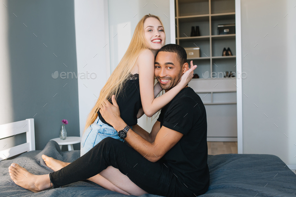 Lovely couple moments of handsome guy and young pretty woman with long blonde hair smiling to camera