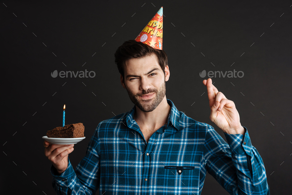 Premium Photo | Positive young man holding a happy birthday cake posing on  a yellow wall.