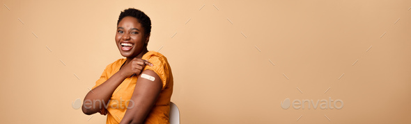 African Female Rolling Up Sleeves Showing Vaccinated Arm, Beige Background