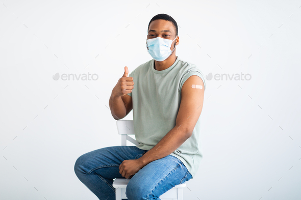 Vaccinated Male Patient Wearing Face Mask Gesturing Thumbs-Up, White Background