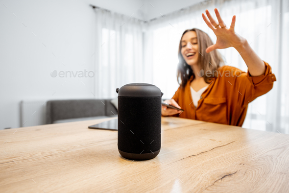 Woman controlling home devices with a voice commands