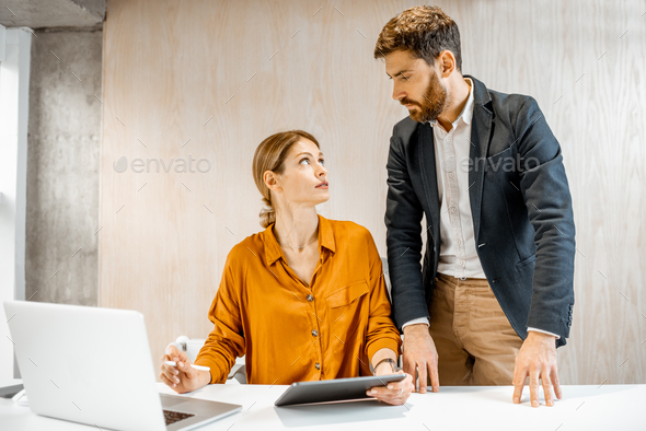 Man and woman talking in the office Stock Photo by RossHelen | PhotoDune