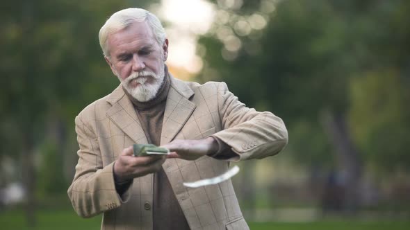 Handsome Aged Man Throwing Around Dollar Bills, Wealth Happiness, Lottery Luck alt