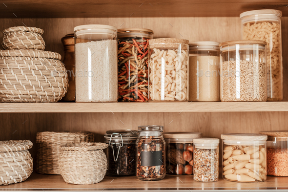 Organizing zero waste storage in kitchen. Pasta and cereals in reusable glass containers in kitchen