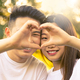 cheerful asian boy and girl shaping a heart with fingers - PhotoDune Item for Sale