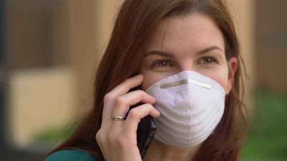  a Girl in a Medical Mask Talking on the Phone