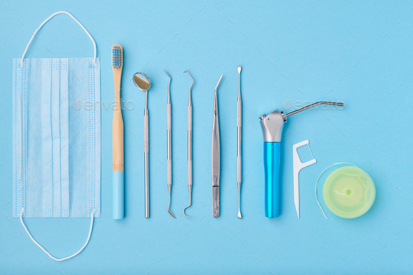 Dentist tools over blue background top view Stock Photo by haveseen