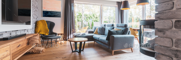 Elegant Living Room With Light Wooden Floor Grey Couch And Wing Back Chair And Big Tv On The Wall Stock Photo By Bialasiewicz