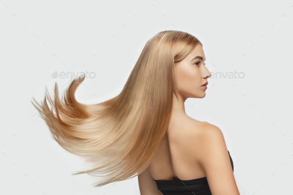 Young blonde girl with long straight hair isolated on white