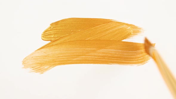 Abstract Brushstrokes of Gold Paint Brush Applied Isolated on a White Background alt
