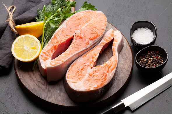 Fresh raw salmon cooking. Fish steaks with herbs and spices - Stock Photo - Images