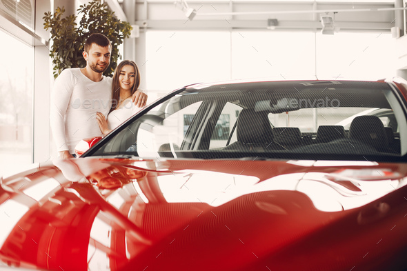 Stylish and elegant family in a car salon - Stock Photo - Images