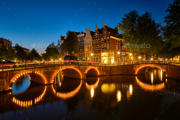 Amterdam canal, bridge and medieval houses in the evening - Stock Photo - Images