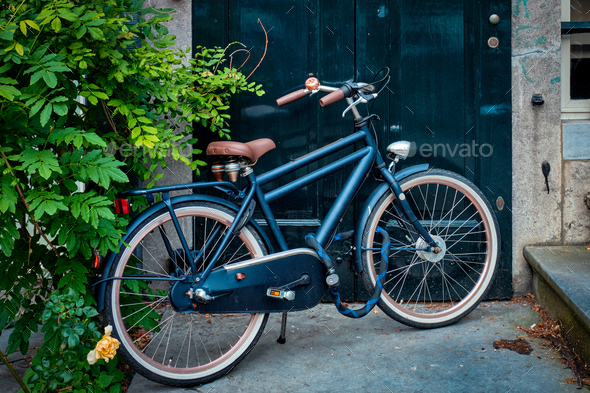Bicycle near door of old house in Amsterdam street - Stock Photo - Images