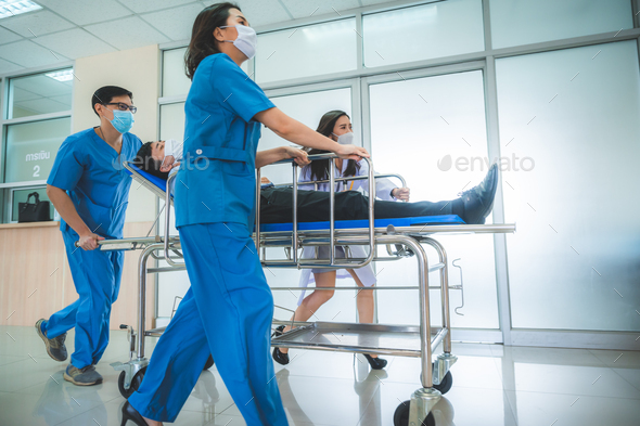 Emergency Department: Doctors and Nurses moving Seriously Injured Unconcious Patient towards