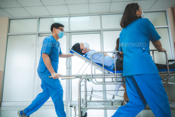 Emergency Department: Doctors and Nurses moving Seriously Injured Unconcious Patient towards