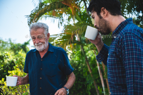 The elderly father and middle-aged son Talking in the house With a coffee cup
