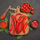 top view a bowl of cherry tomatoes hot red peppers on the chopping board a wooden spoon bay leaves - PhotoDune Item for Sale