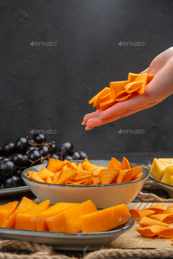 Vertical view of best delicious snacks on an old newspaper rope and ...