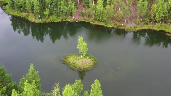 Aerial view of a forest lake with small island.