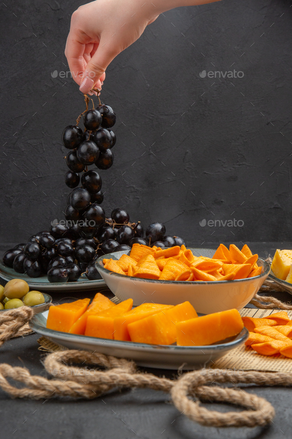 Vertical view of best delicious snacks on an old newspaper rope and ...