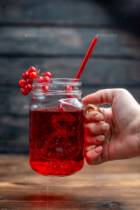 front view fresh cranberry juice inside can with straw on a dark background bar fruit photo