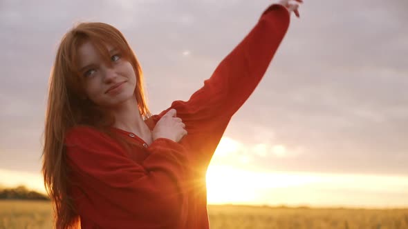Beautiful Redhead Girl Romantic Woman with Red Hair Smiling and Playing in Wheat Field Walking Along