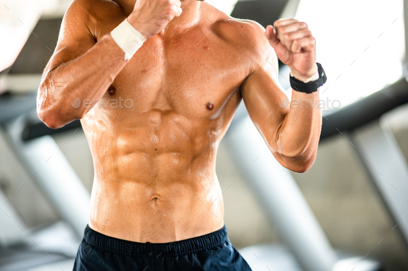 Close Up of a strong muscular young man in sport gym, strong and beautiful muscles