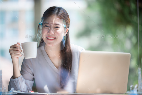 Asian women wearing face shield at the coffee cafe, a way to prevent communicable