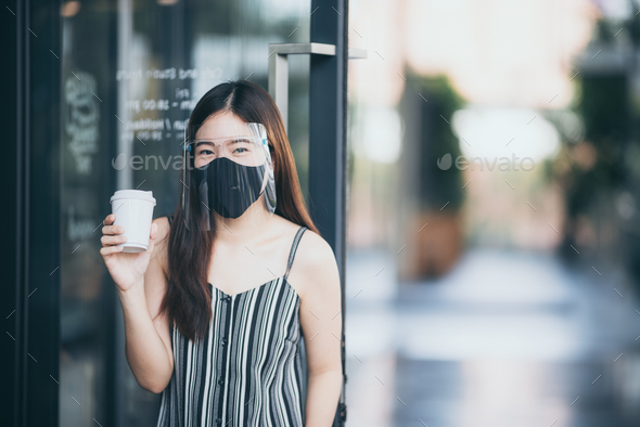 Asian women wearing face shield at the coffee cafe, a way to prevent communicable diseases